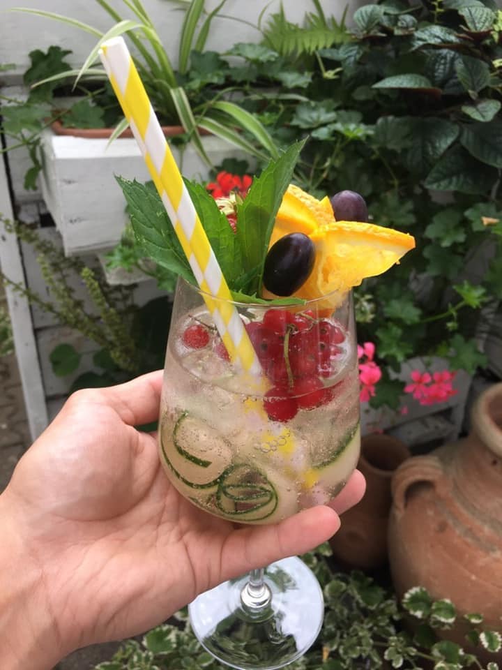 Refreshing drink with fruits, cucumber, and berries