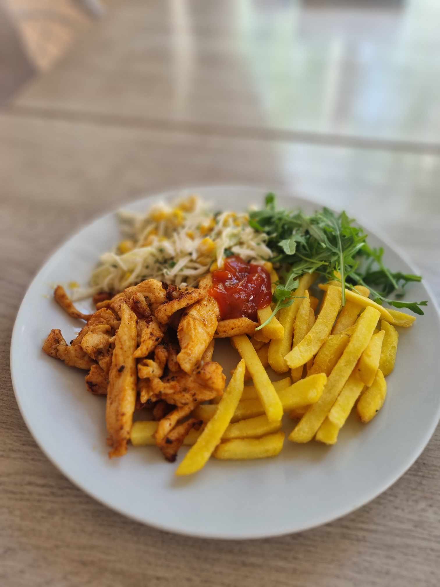 Chicken strips with french fries, pasta, and salad